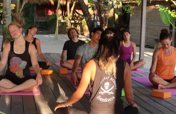 Selin leading a meditation session in a bungalow